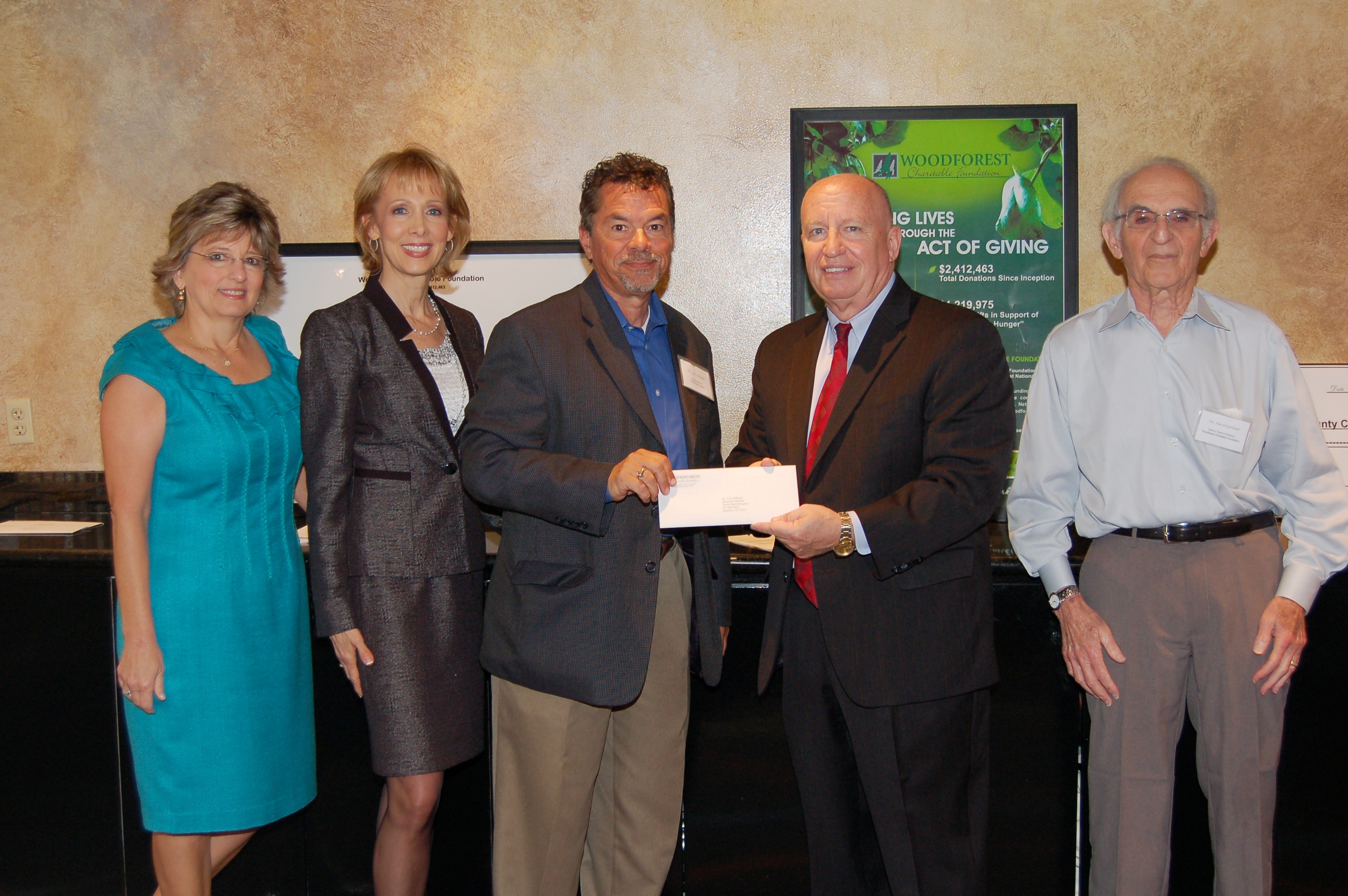 Youth-Reach Houston receives $1,000 donation from Woodforest Charitable Foundation.